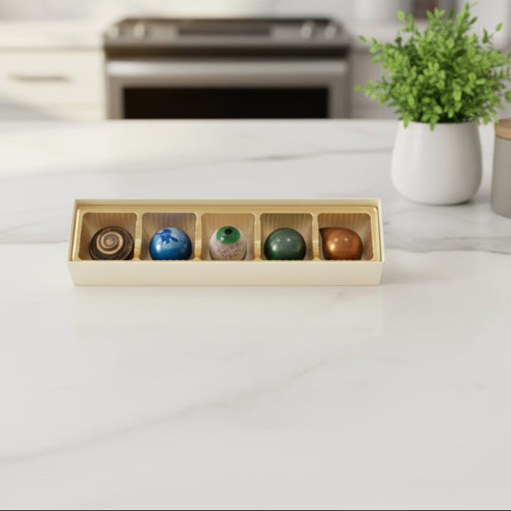 5-Piece box of chocolate bonbons on a marble counter