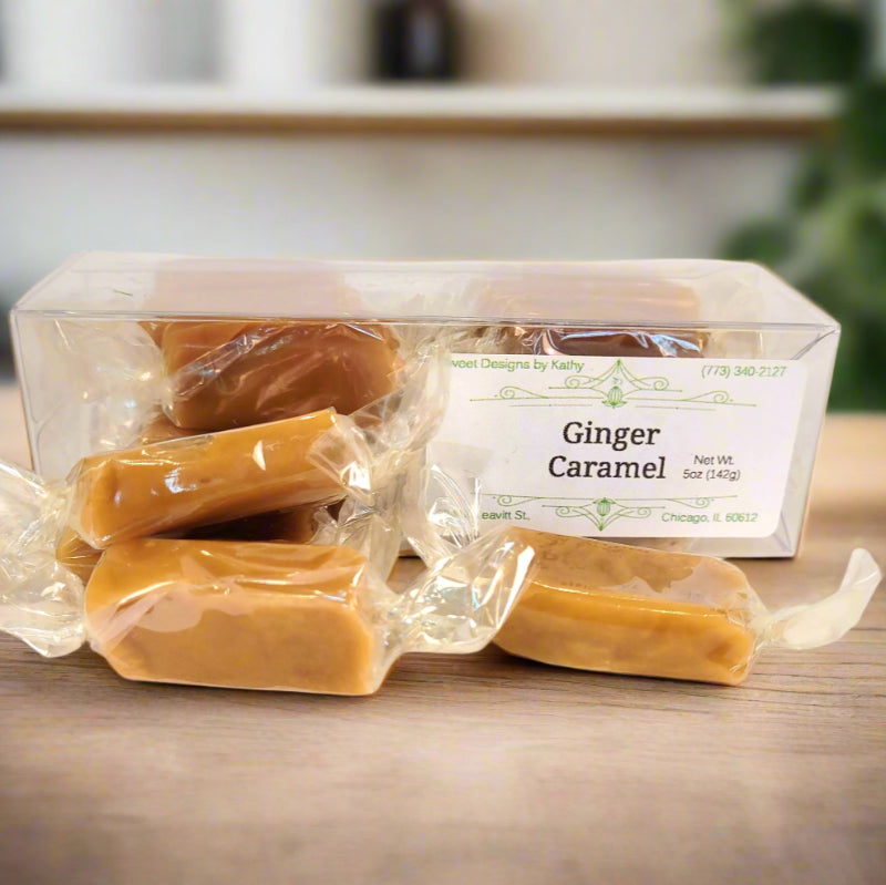 Ginger caramel treats in clear packaging on a wooden surface.