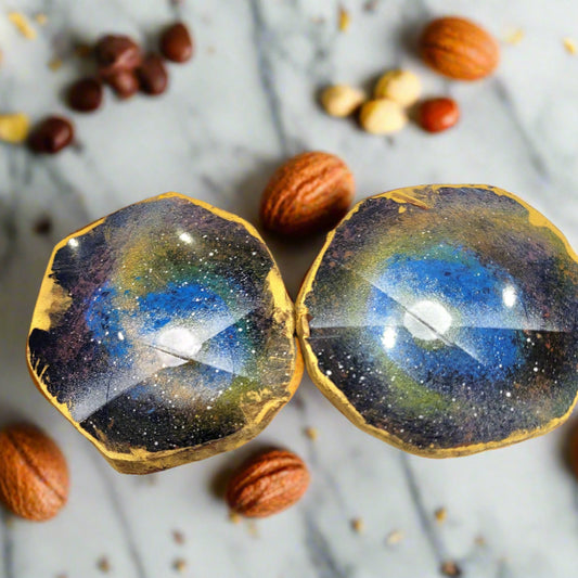 Two hexagonal chocolates with a starry night design and peanut nougat and peanut caramel inside