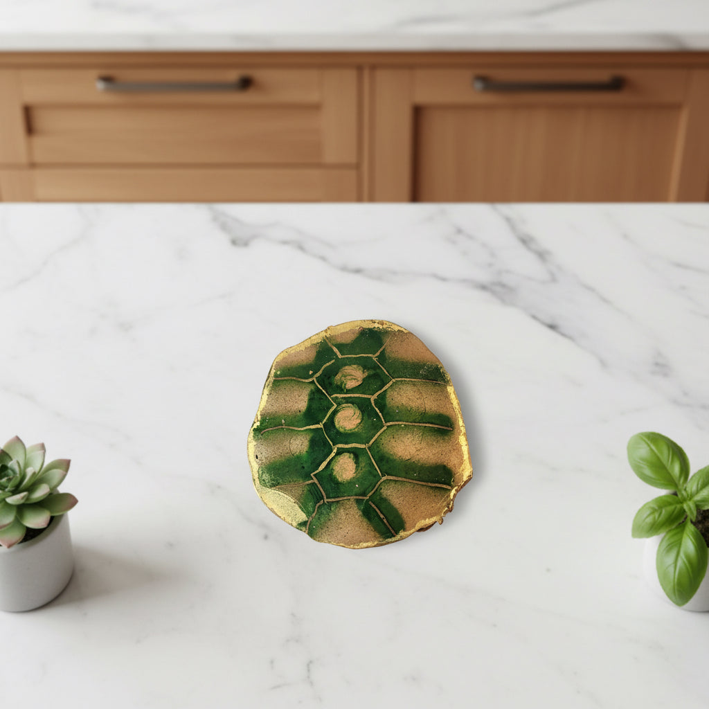 Chocolate disc painted to look like a turtle shell with copper and green