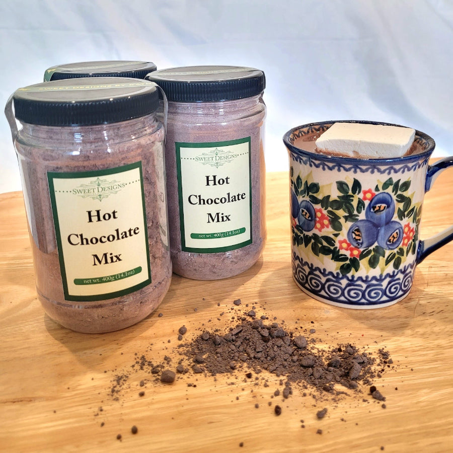 Hot chocolate in jars with a mug of hot chocolate with a marshmallow.