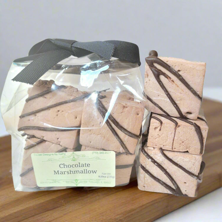 chocolate marshmallows with chocolate drizzle in a bag and loose on a counter top