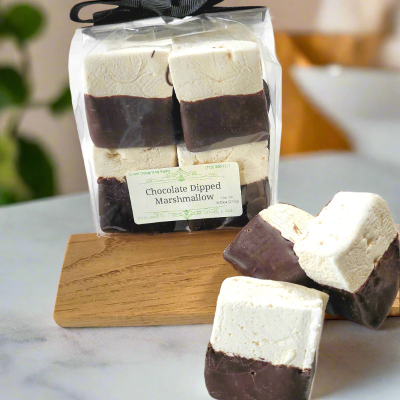 chocolate dipped vanilla marshmallows loose and in a bag on a counter