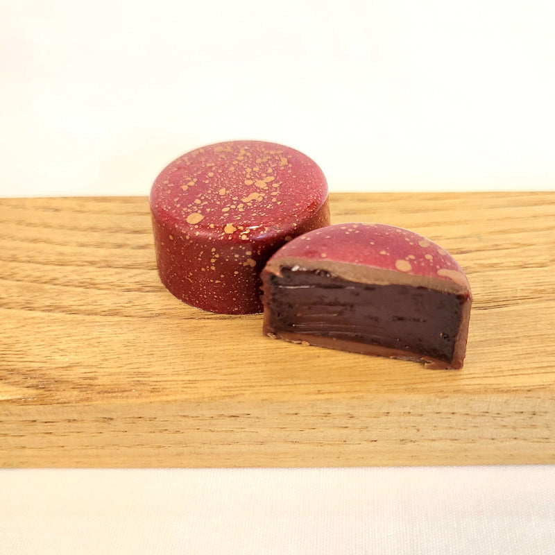 Aztec hot chocolate flavored chocolate cut open to see inside with ancho chili and cinnamon