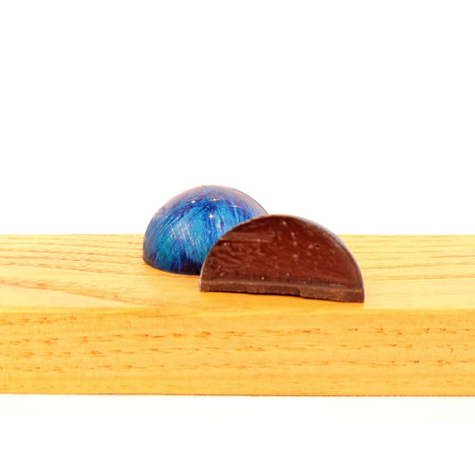 blue marbled chocolate cut open to see Whiskey Old Fashioned Ganache inside