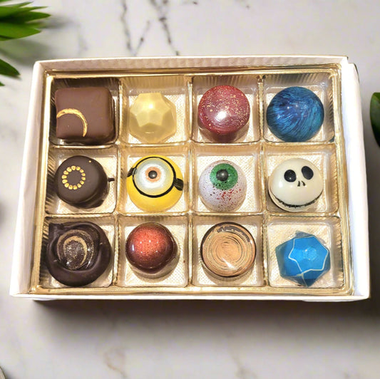 Box of colorful halloween themed chocolate bonbons on a marble surface