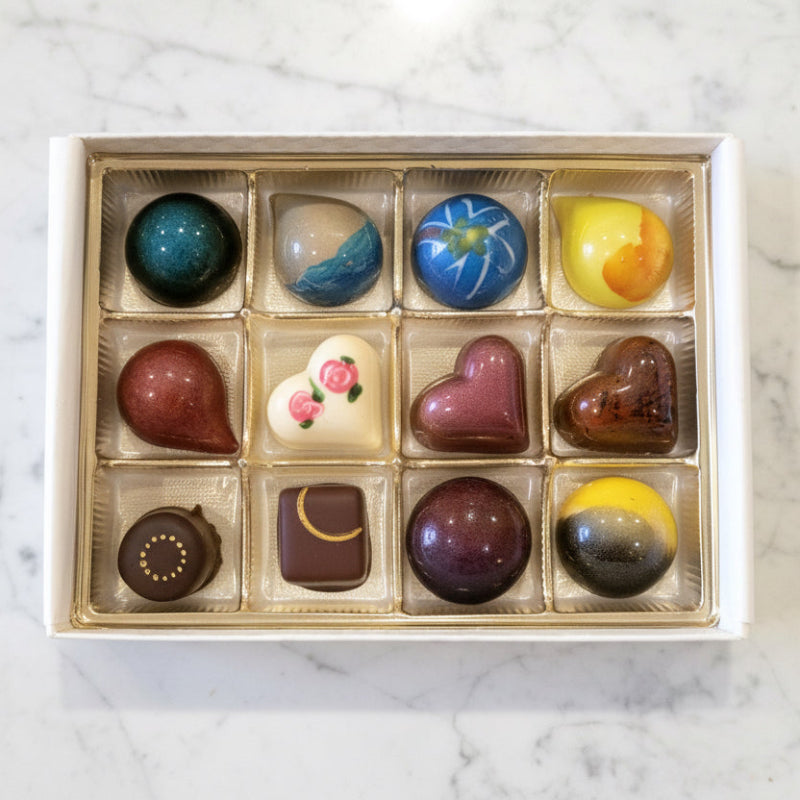 Box of assorted chocolates on a marble surface