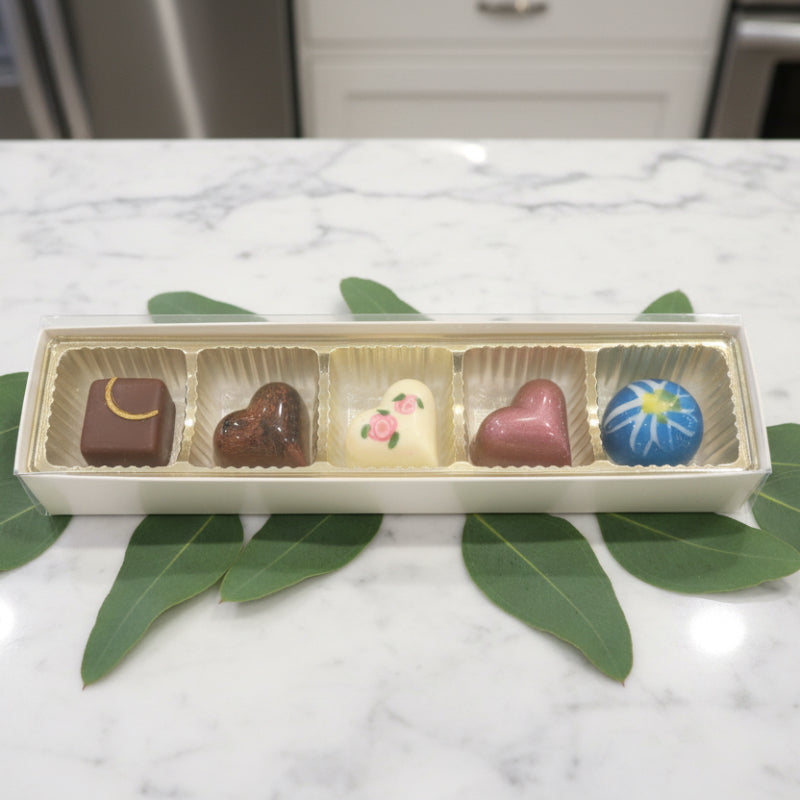 Box of assorted chocolates on a granite countertop